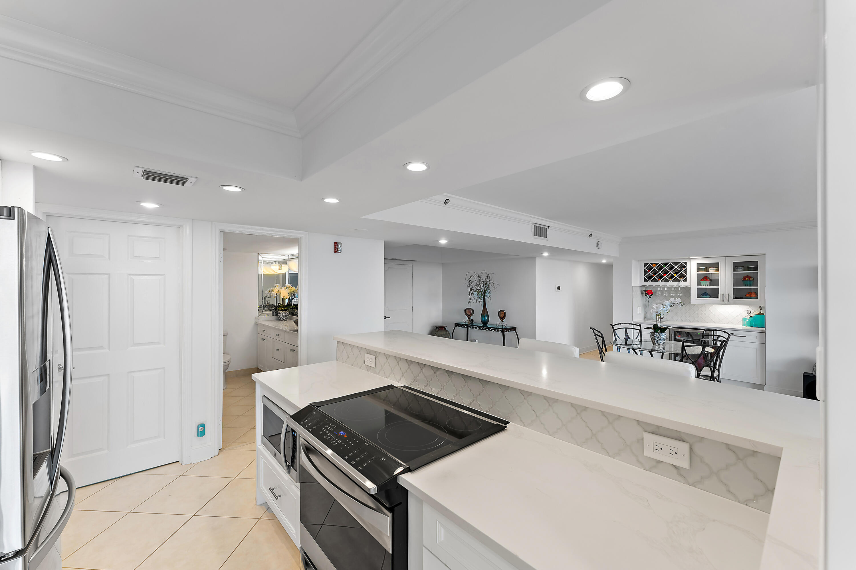 5280 North Ocean Drive, Unit 2F Singer Island, FL 33404 - Photo 16 of 92 a large kitchen with a large counter top appliances and cabinets