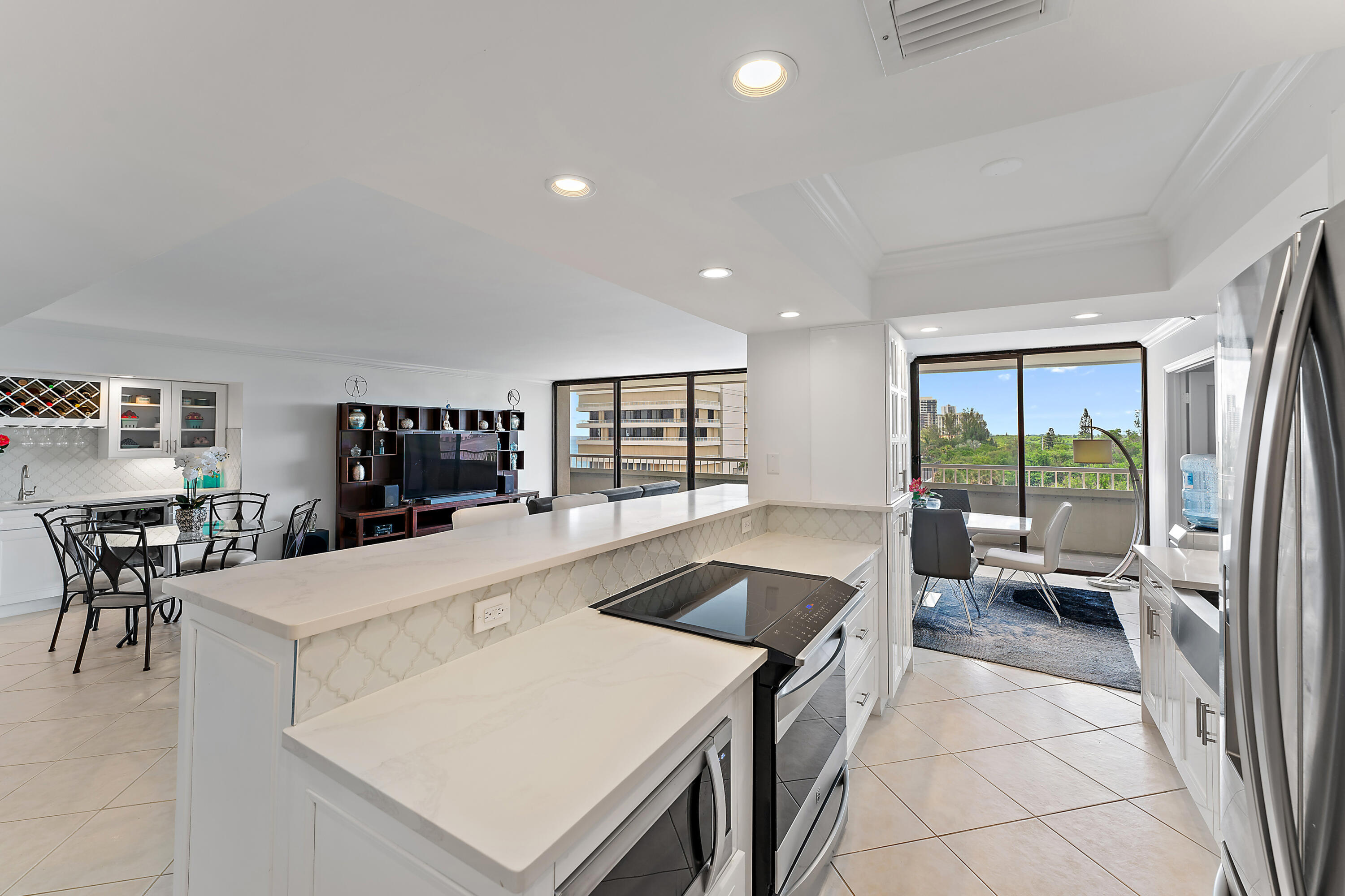 5280 North Ocean Drive, Unit 2F Singer Island, FL 33404 - Photo 18 of 92 a large white kitchen with a large window