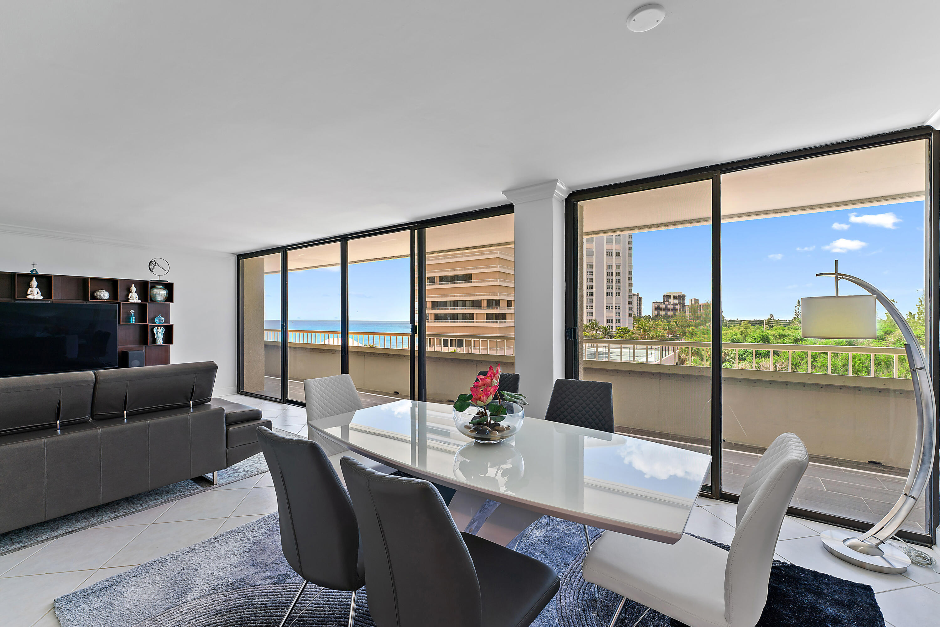 5280 North Ocean Drive, Unit 2F Singer Island, FL 33404 - Photo 19 of 92 a dining room with furniture a chandelier and wooden floor