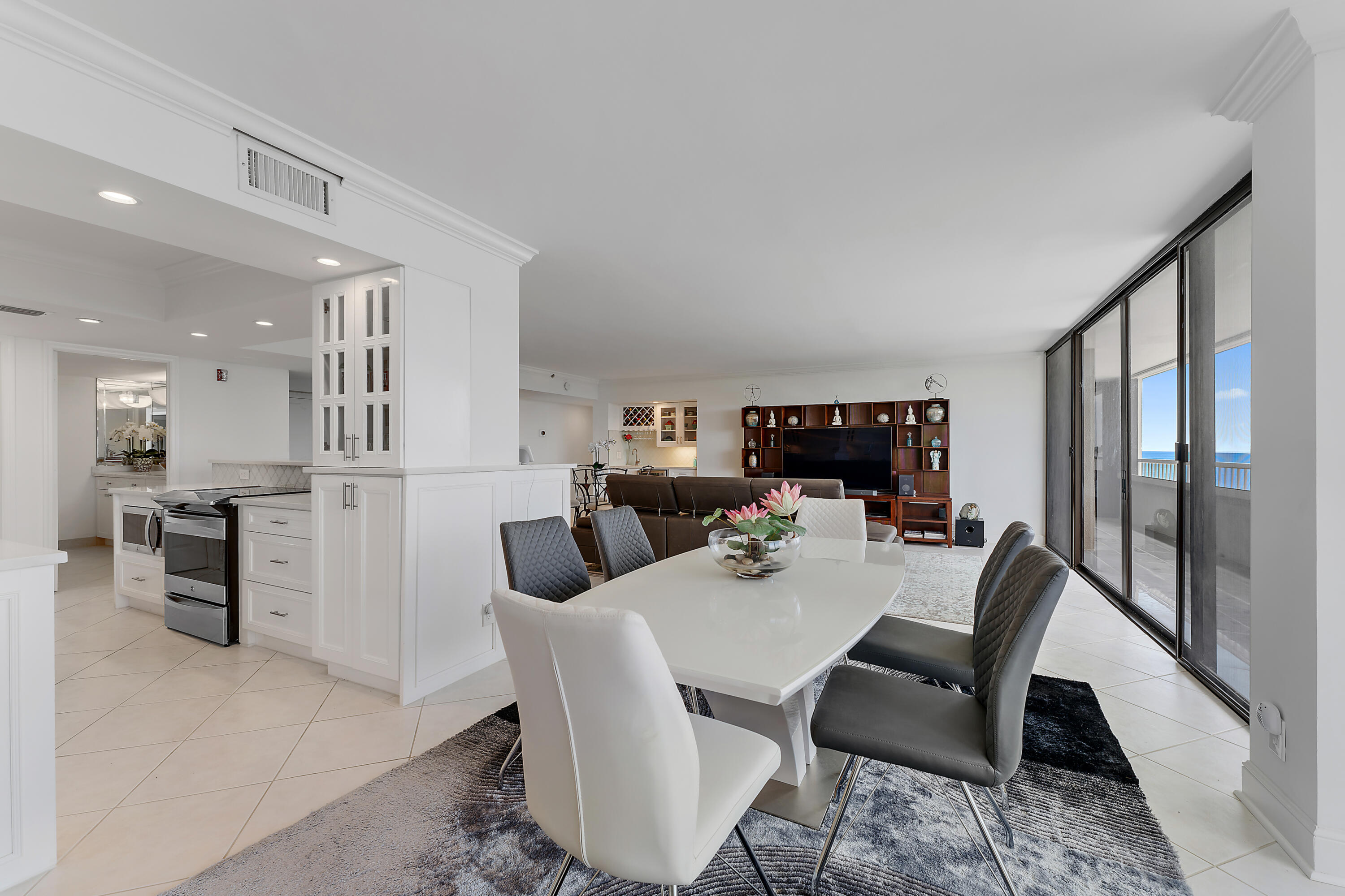 5280 North Ocean Drive, Unit 2F Singer Island, FL 33404 - Photo 24 of 92 a view of a dining room with furniture window and wooden floor
