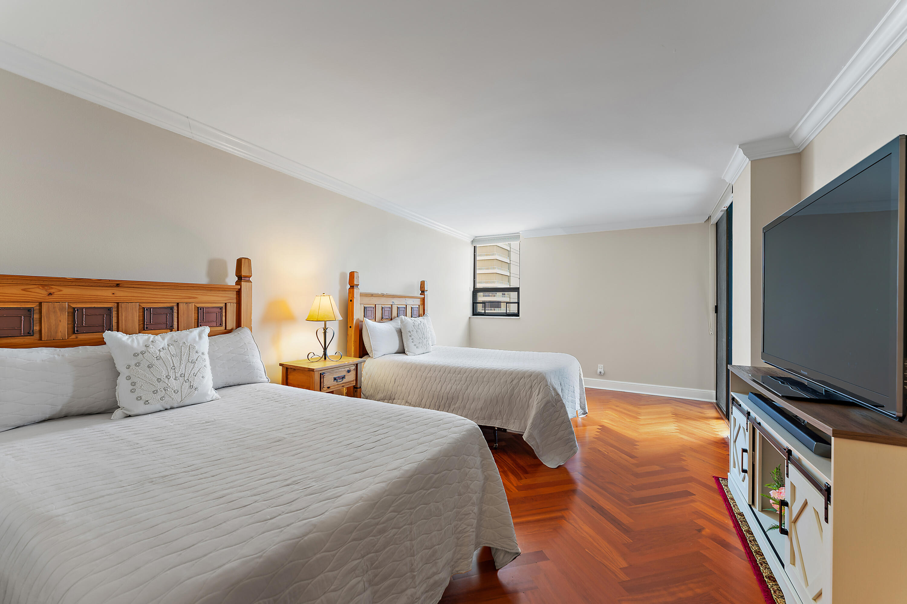 5280 North Ocean Drive, Unit 2F Singer Island, FL 33404 - Photo 31 of 92 a bedroom with a bed and a flat screen tv