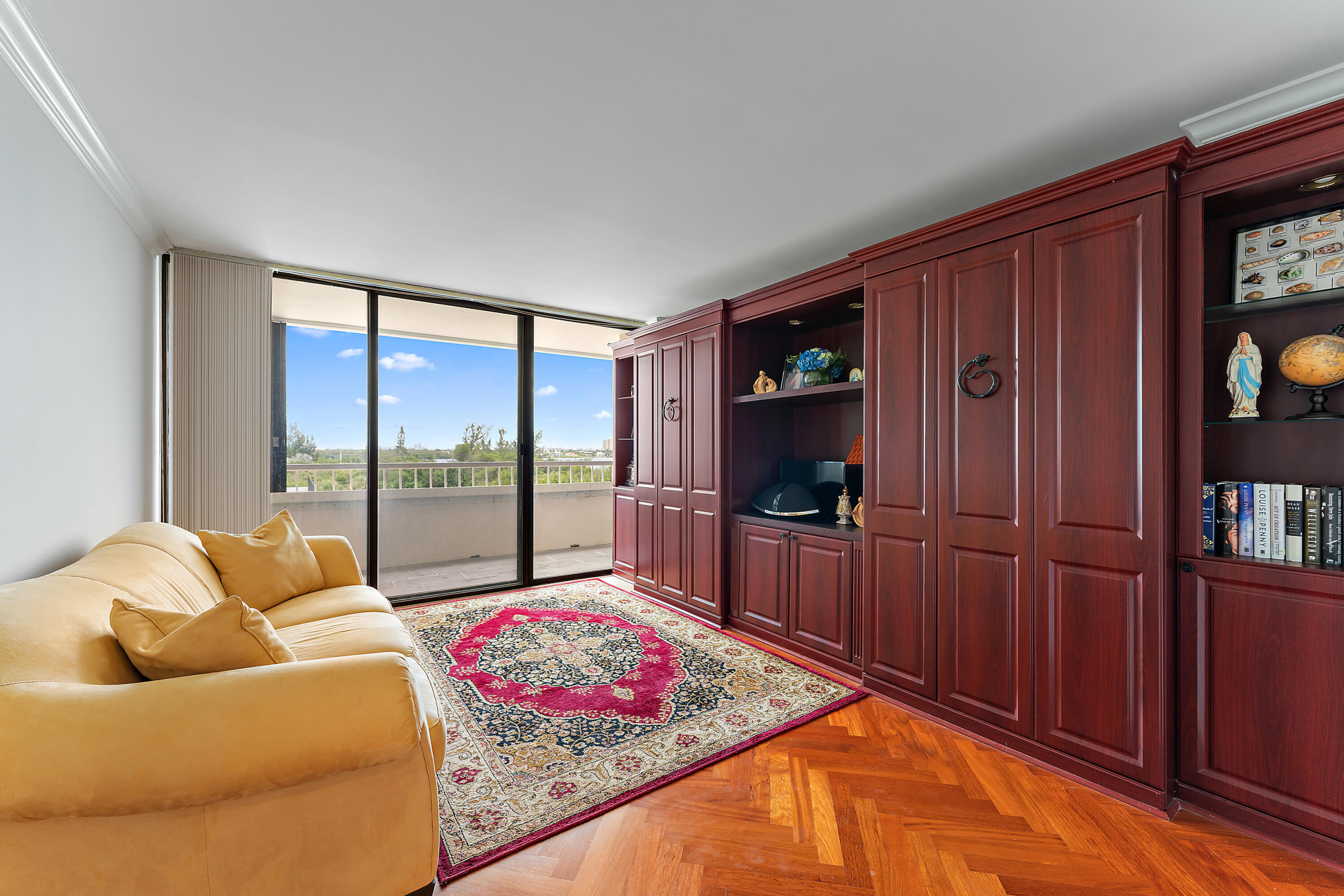 5280 North Ocean Drive, Unit 2F Singer Island, FL 33404 - Photo 36 of 92 a living room with furniture a flat screen tv and a floor to ceiling window
