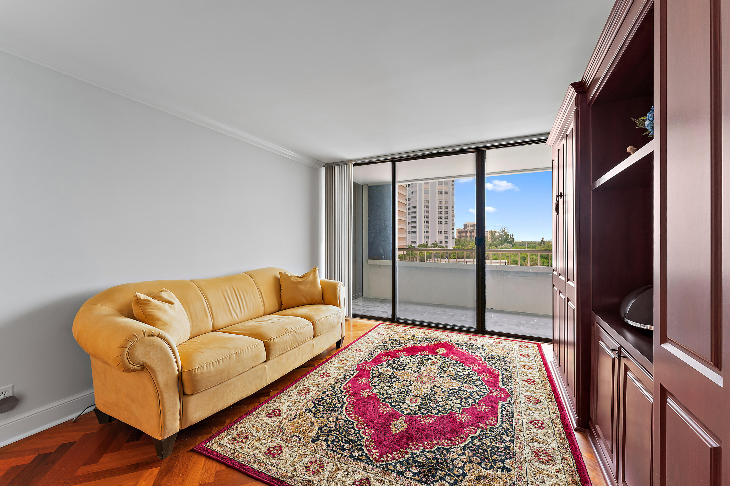 5280 North Ocean Drive, Unit 2F Singer Island, FL 33404 - Photo 37 of 92 a living room with a couch and a floor to ceiling window