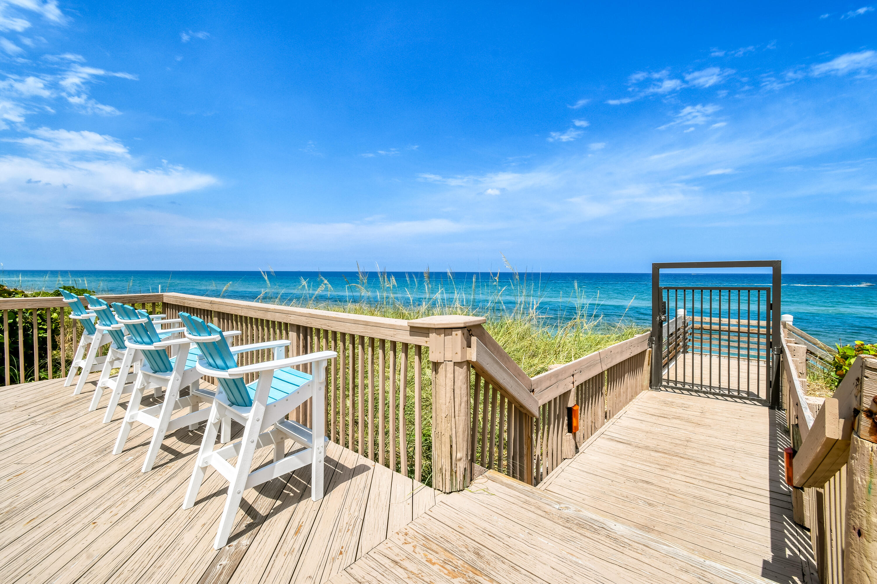 5280 North Ocean Drive, Unit 2F Singer Island, FL 33404 - Photo 4 of 92 a view of a balcony with wooden floor and outdoor seating