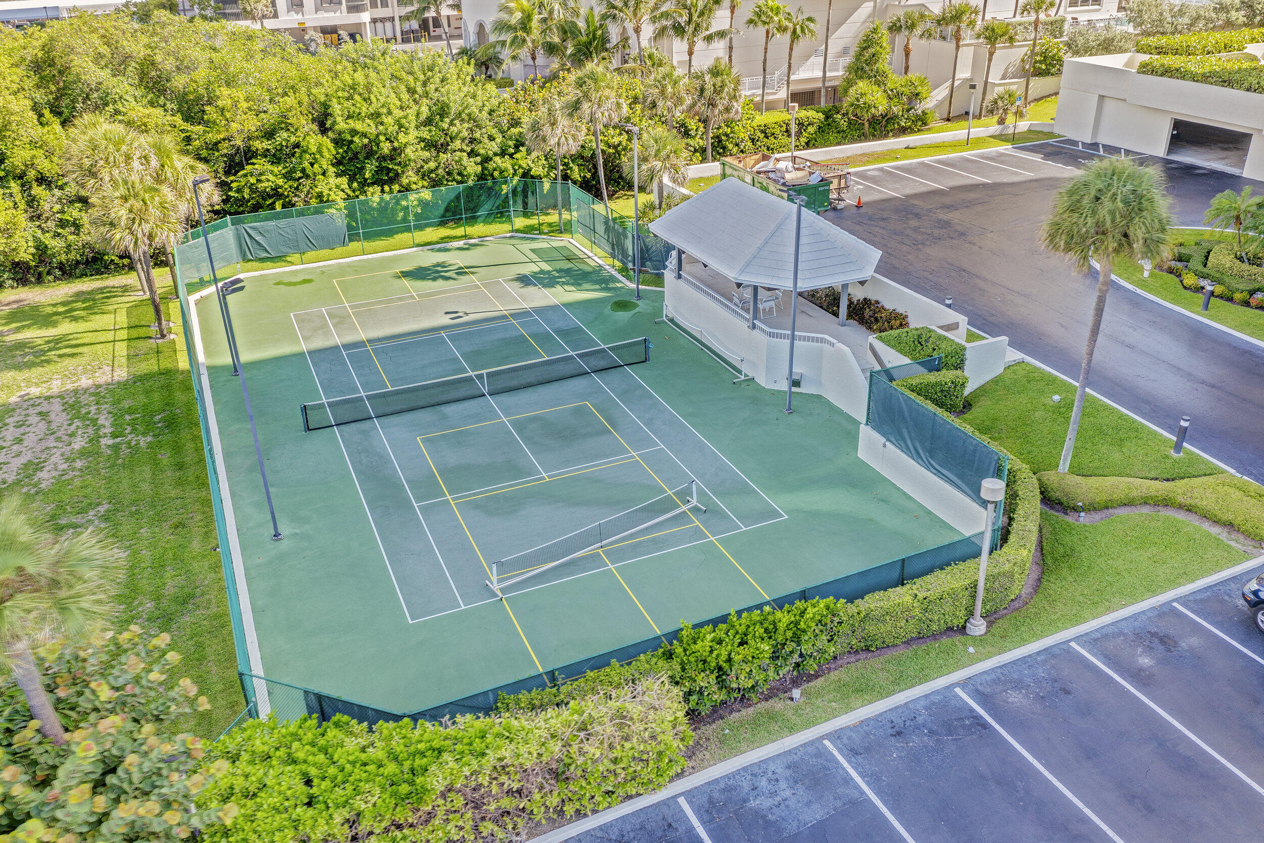 5280 North Ocean Drive, Unit 2F Singer Island, FL 33404 - Photo 64 of 92 an aerial view of a tennis ground and large trees
