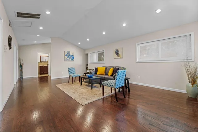 a living room with furniture and wooden floor