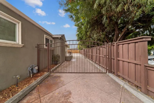 a view of a house with wooden fence