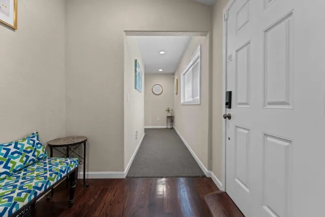 a view of a room with wooden floor
