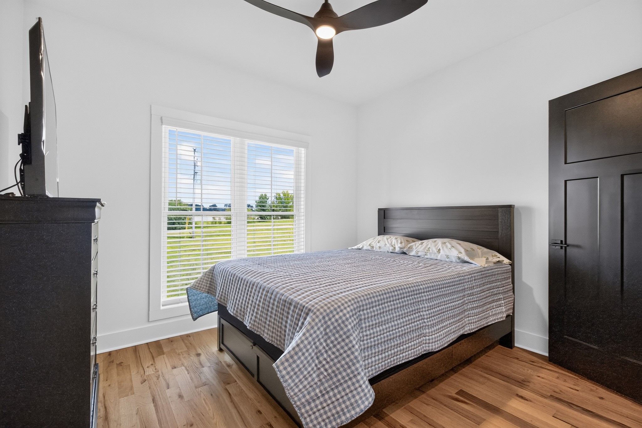 28 Harding Road Leoma, TN 38468 - Photo 21 of 36 a bedroom with a bed and wooden floor