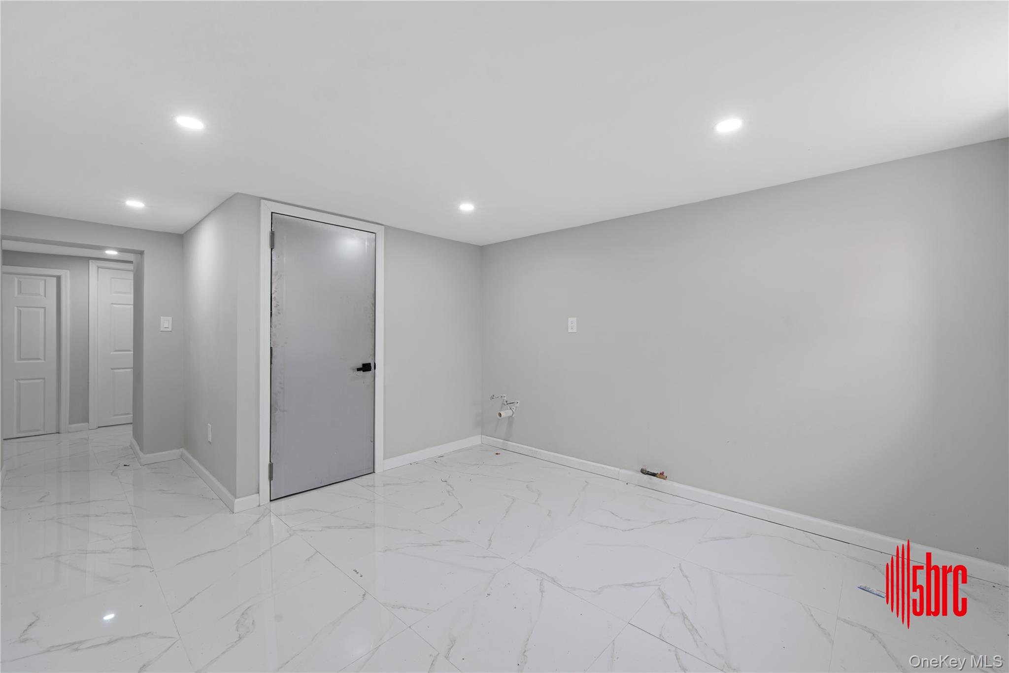 217-39 114th Road Queens, NY 11411 - Photo 10 of 23 Below grade area featuring recessed lighting and light marble finish floors