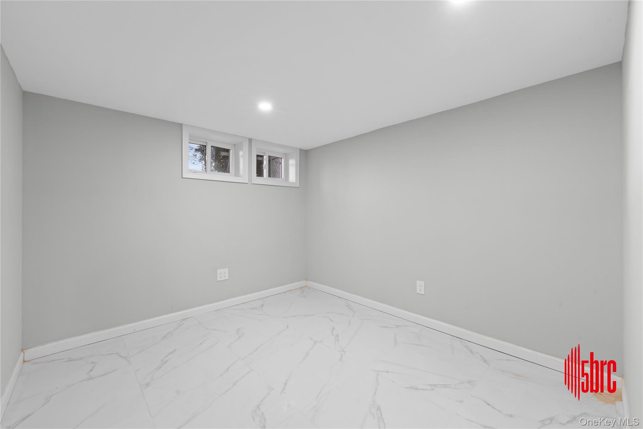 217-39 114th Road Queens, NY 11411 - Photo 13 of 23 Basement featuring marble finish flooring and recessed lighting