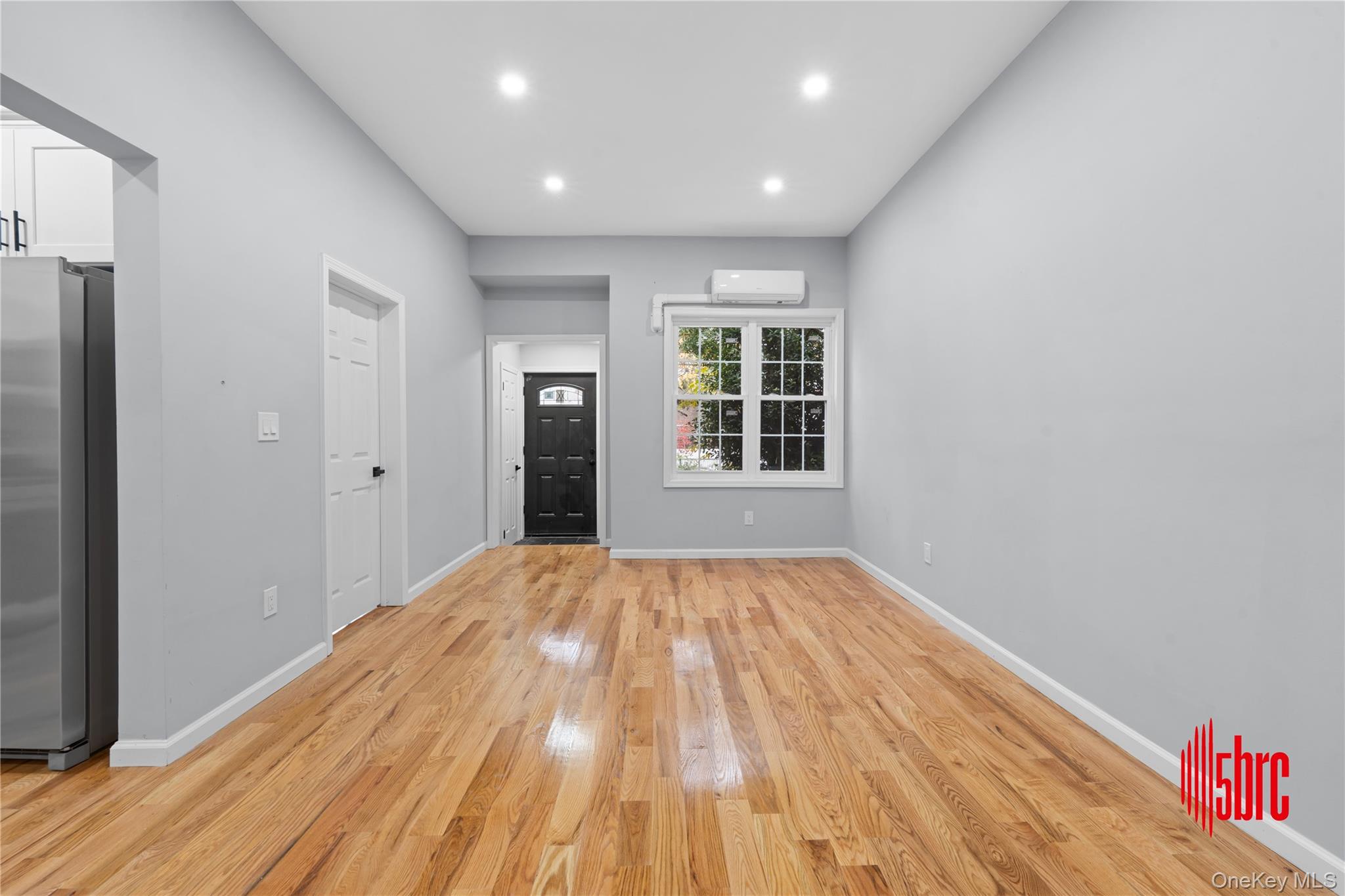 Entryway with light wood-style floors and recessed lighting