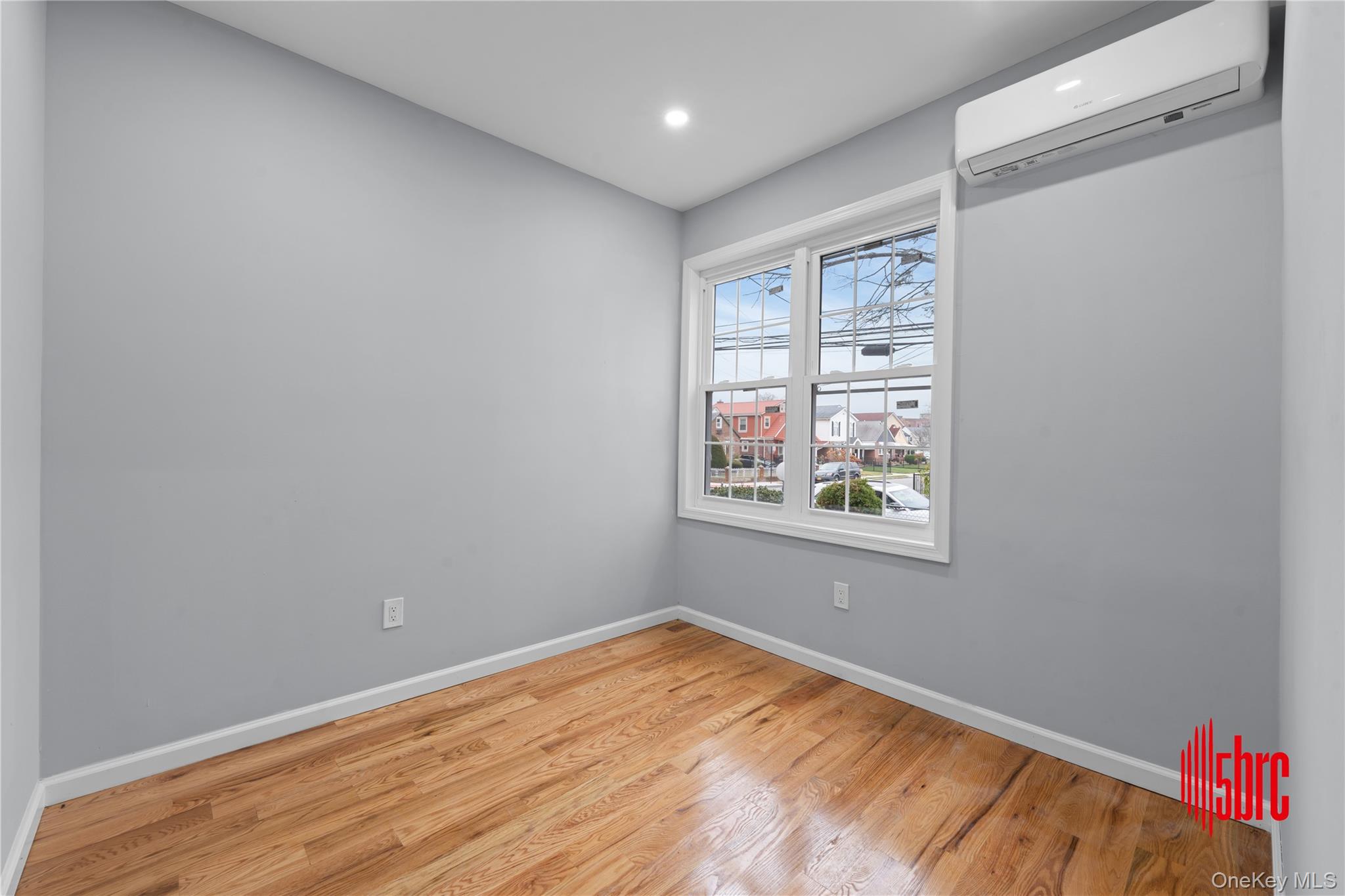 217-39 114th Road Queens, NY 11411 - Photo 7 of 23 Empty room with a wall mounted AC, light wood-style flooring, and recessed lighting