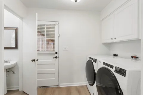 a bathroom with a sink and mirror with bathtub
