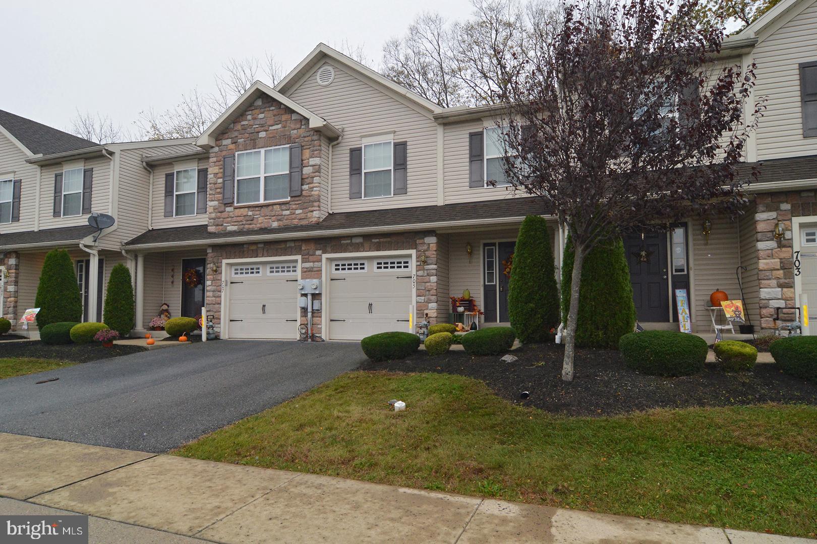 705 Caramist Circle Sinking Spring, PA 19608 - Photo 2 of 54 a front view of a house with a yard