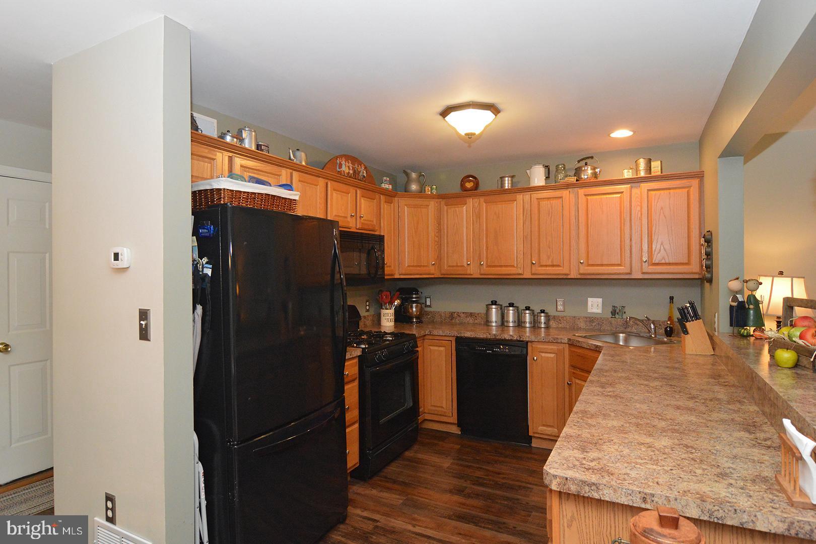 705 Caramist Circle Sinking Spring, PA 19608 - Photo 12 of 54 a kitchen with stainless steel appliances granite countertop a refrigerator and a stove