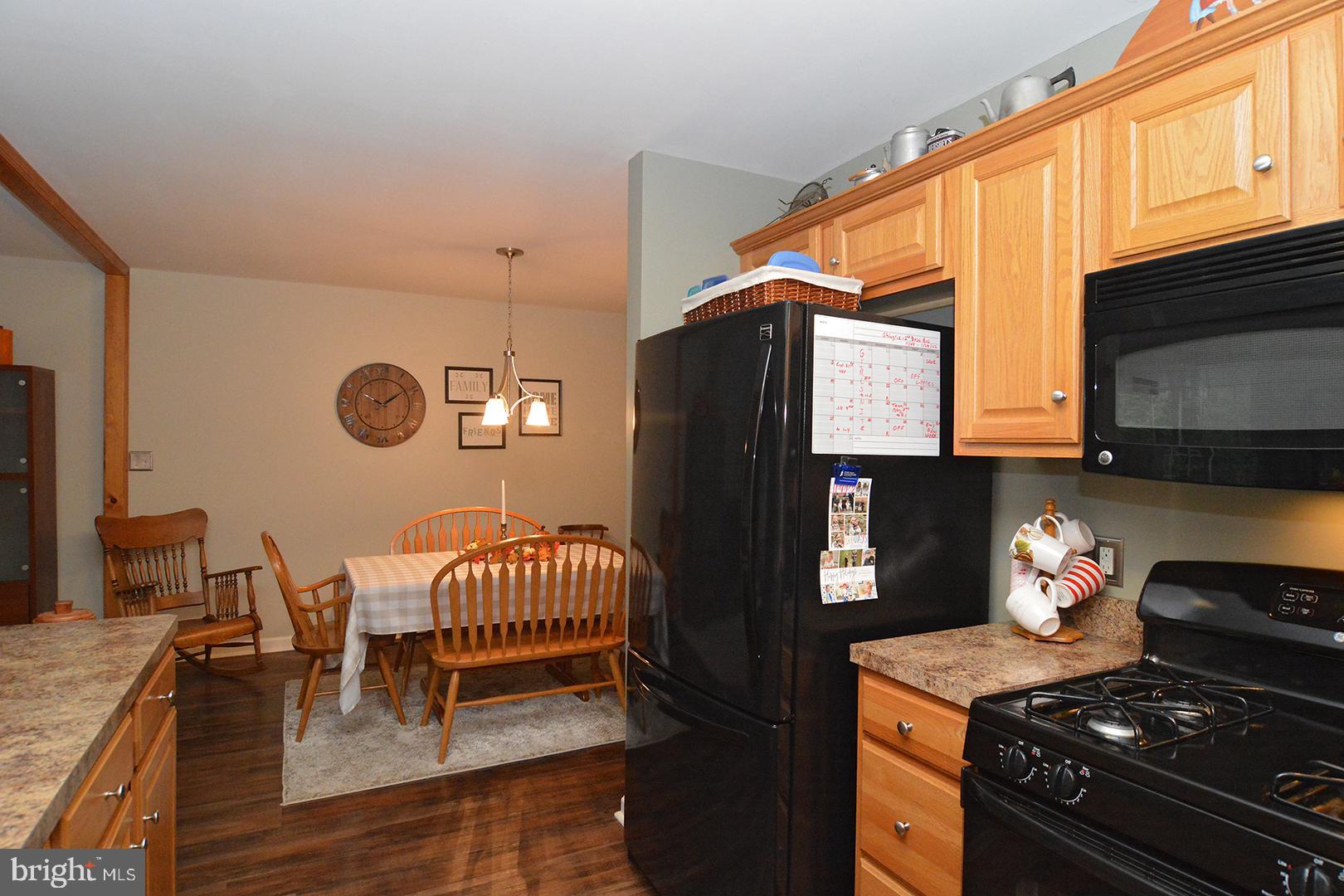 705 Caramist Circle Sinking Spring, PA 19608 - Photo 15 of 54 a kitchen with stainless steel appliances granite countertop a stove a refrigerator and a dining table