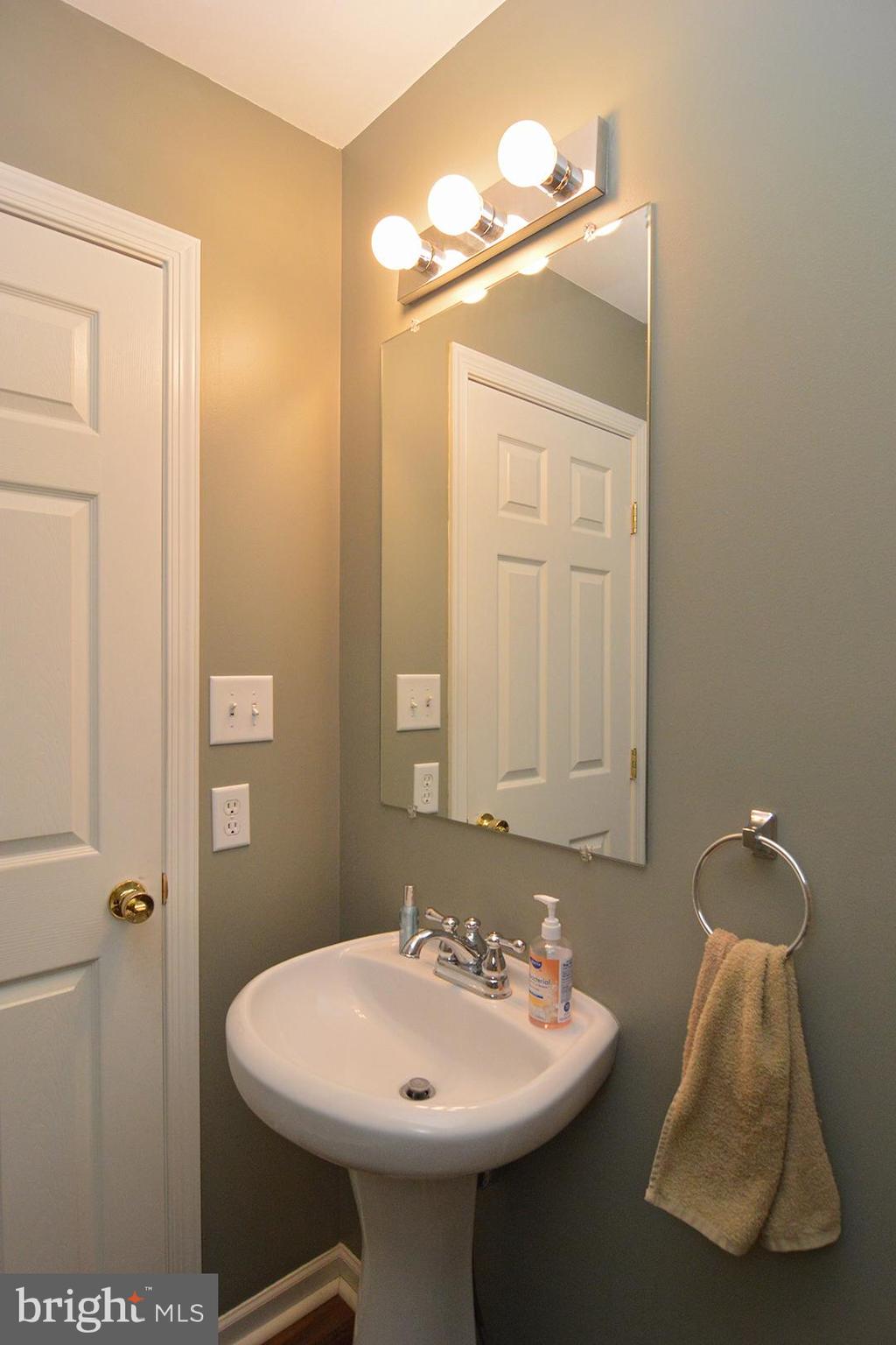 705 Caramist Circle Sinking Spring, PA 19608 - Photo 23 of 54 a bathroom with a sink and a mirror