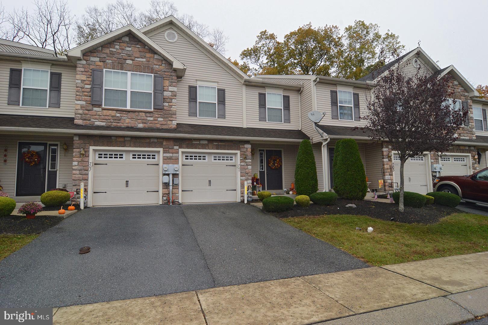 705 Caramist Circle Sinking Spring, PA 19608 - Photo 4 of 54 a front view of a house with a yard and garage