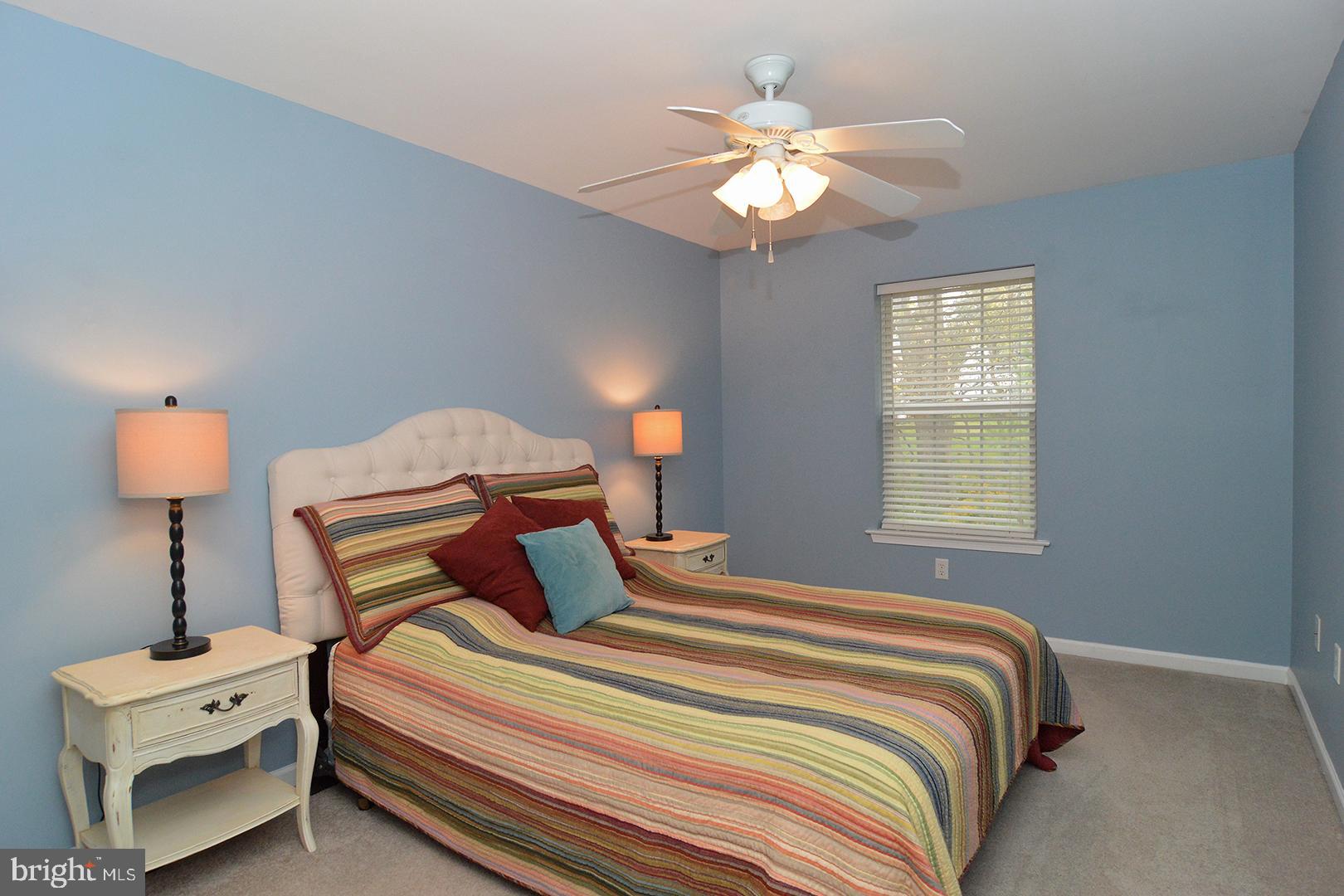 705 Caramist Circle Sinking Spring, PA 19608 - Photo 34 of 54 a bedroom with a bed and a lamp