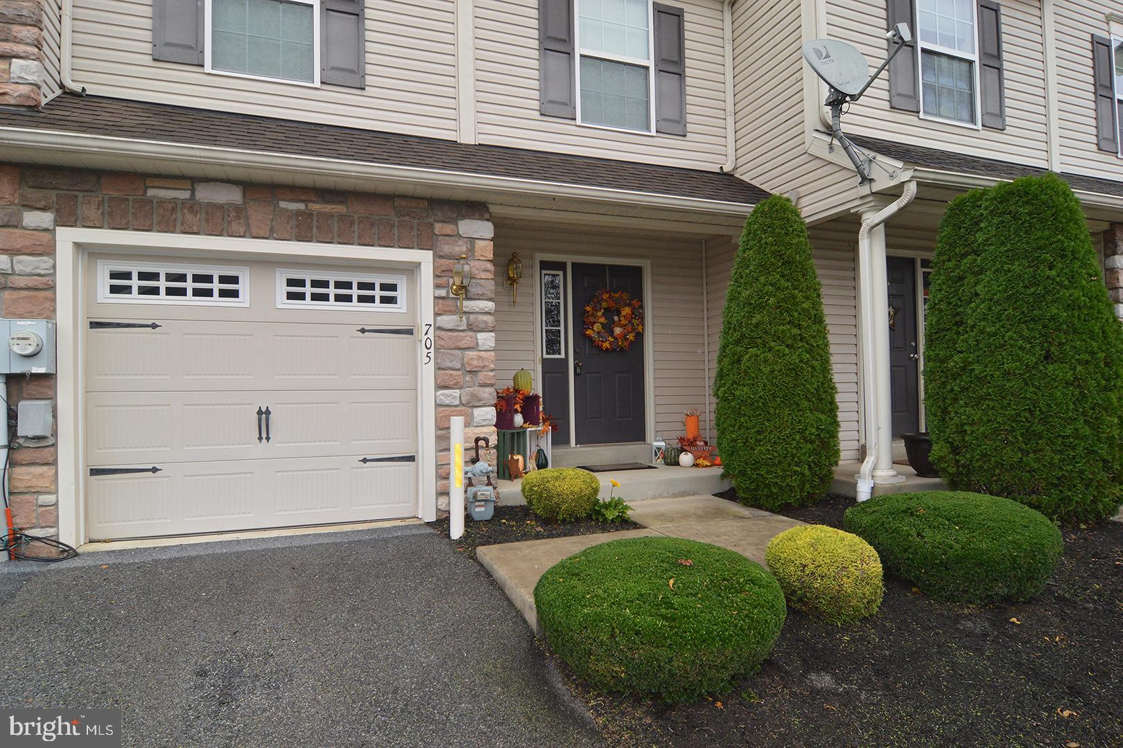 705 Caramist Circle Sinking Spring, PA 19608 - Photo 5 of 54 a front view of a house with garden