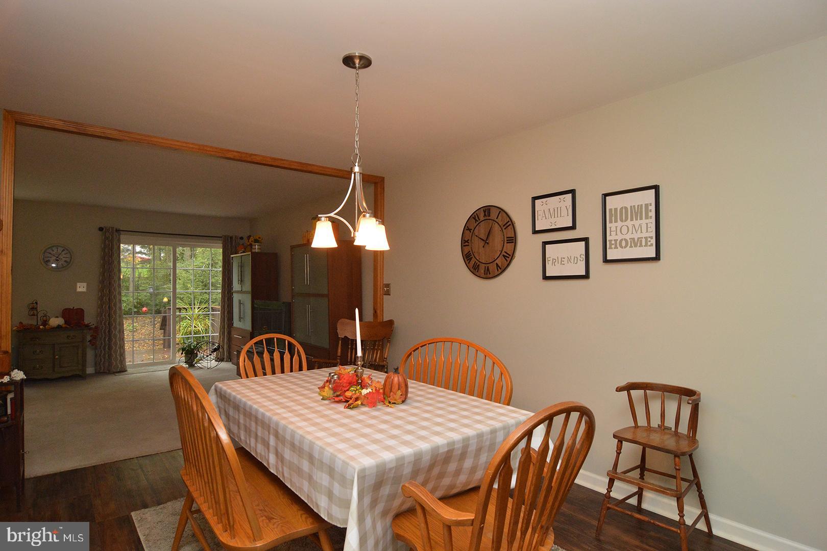 705 Caramist Circle Sinking Spring, PA 19608 - Photo 8 of 54 a view of a dining room and a table chairs and chandelier