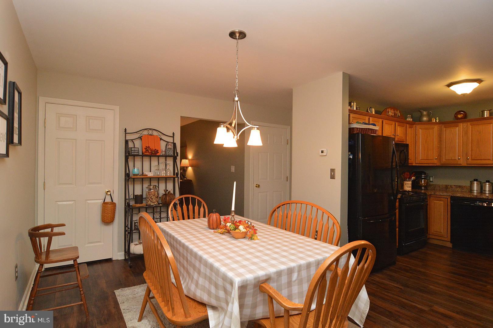 705 Caramist Circle Sinking Spring, PA 19608 - Photo 10 of 54 a dining room with furniture and wooden floor