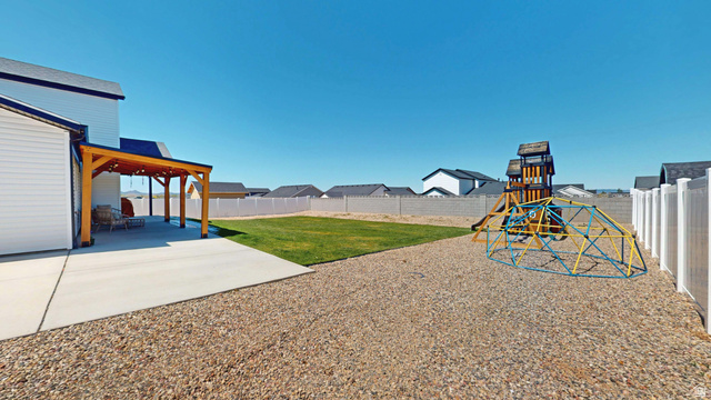 1127 4240 North Enoch, UT 84721 - Photo 49 of 56 Fenced backyard with a patio, a residential view, and a playground