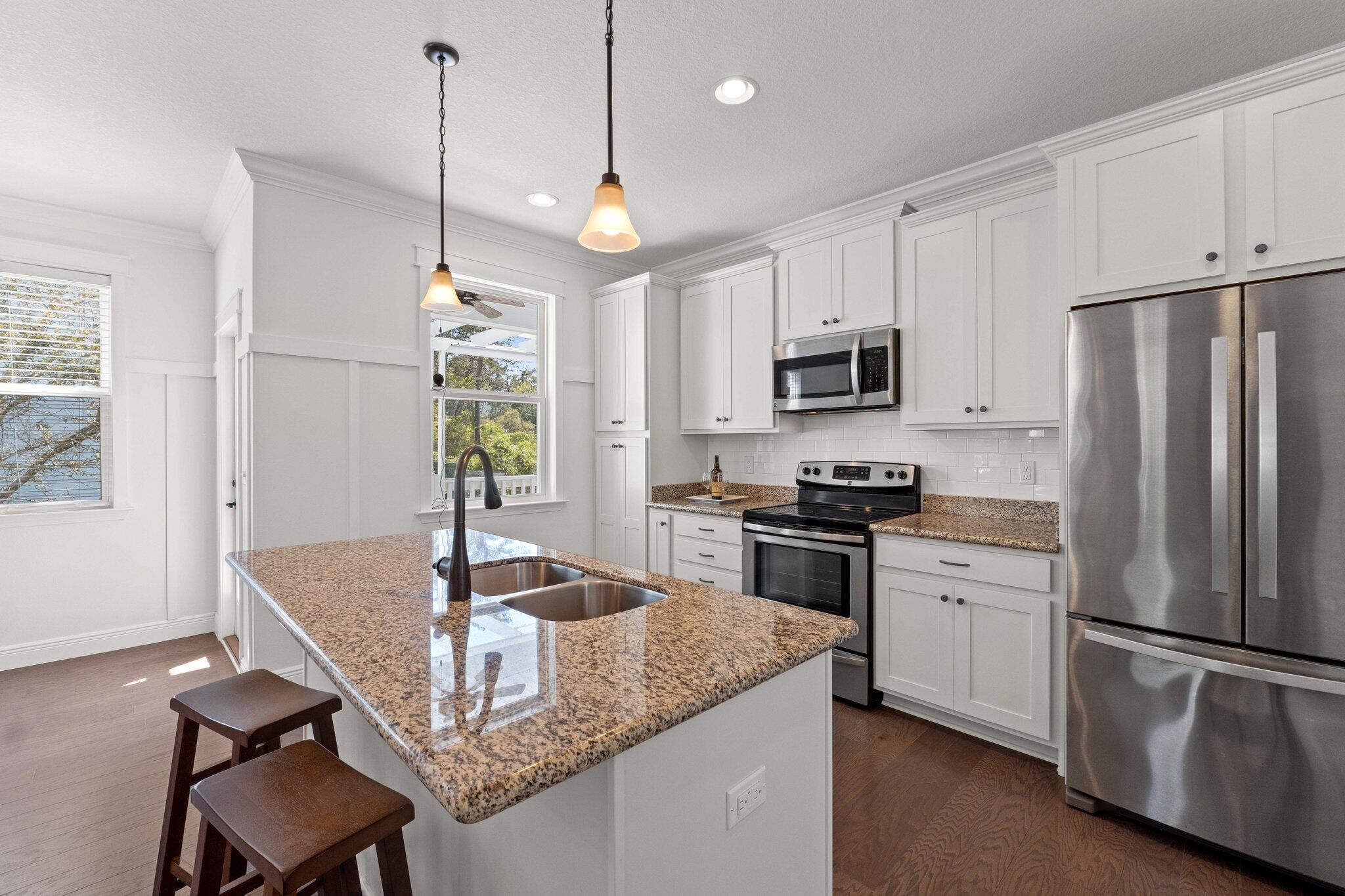 96 Sandpine Loop Inlet Beach, FL 32461 - Photo 12 of 38 a kitchen with kitchen island a refrigerator stove microwave and cabinets
