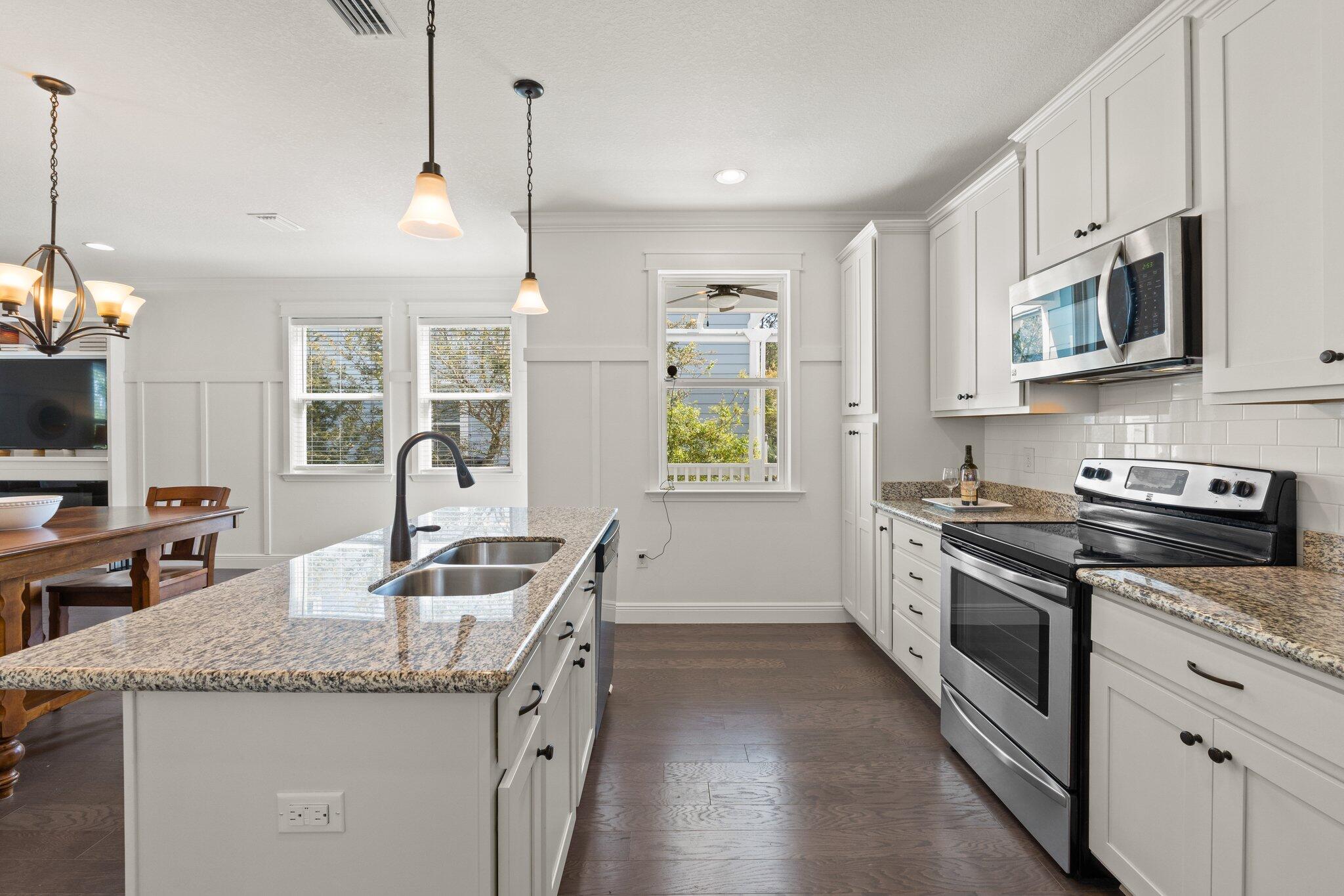 96 Sandpine Loop Inlet Beach, FL 32461 - Photo 13 of 38 a kitchen with stainless steel appliances granite countertop a sink a stove and a granite counter tops