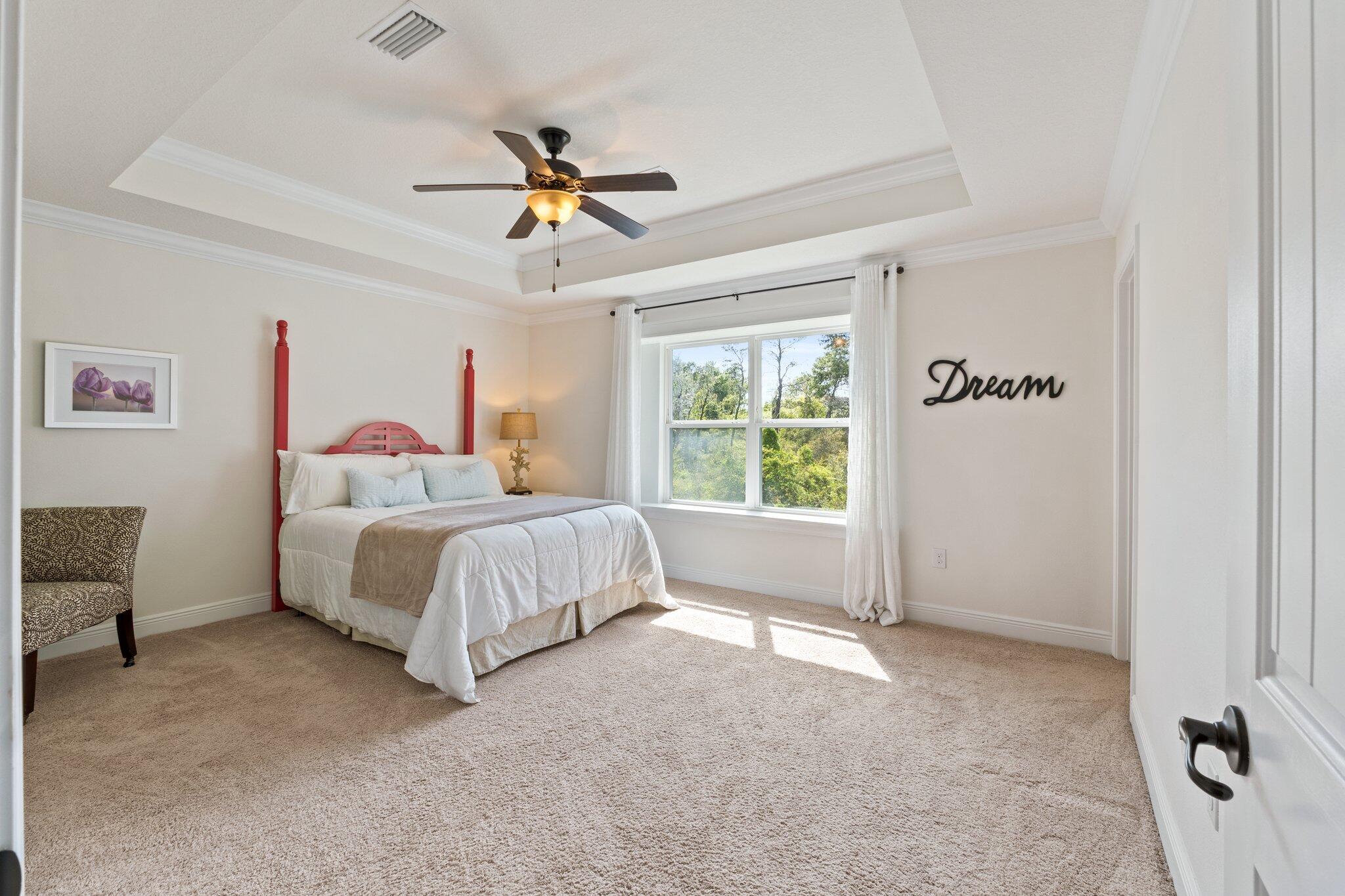 96 Sandpine Loop Inlet Beach, FL 32461 - Photo 21 of 38 a spacious bedroom with a bed and a chandelier