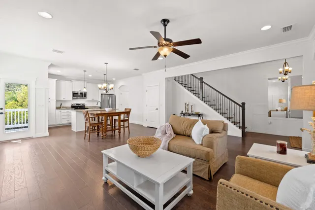 a living room with furniture and a view of kitchen