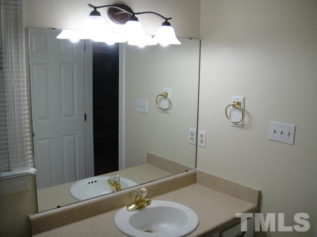 550 Weathergreen Drive Raleigh, NC 27615 - Photo 13 of 25 a bathroom with a sink and a mirror