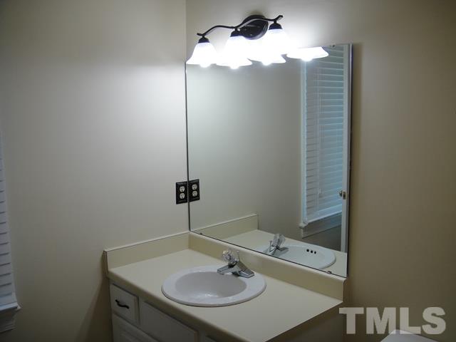 550 Weathergreen Drive Raleigh, NC 27615 - Photo 16 of 25 a bathroom with a sink and a mirror
