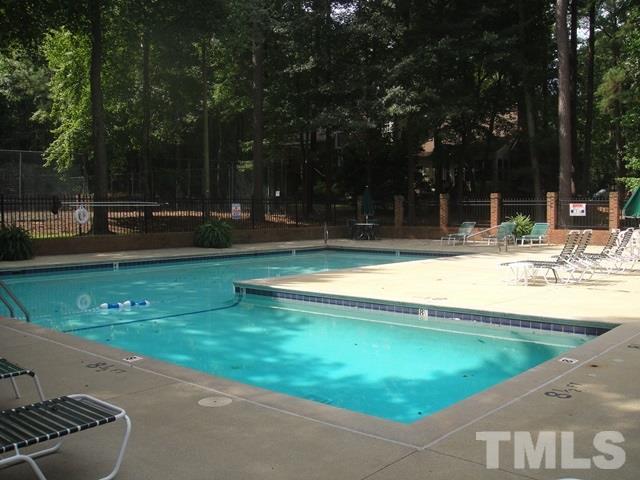 550 Weathergreen Drive Raleigh, NC 27615 - Photo 23 of 25 a view of a swimming pool with a yard and trees