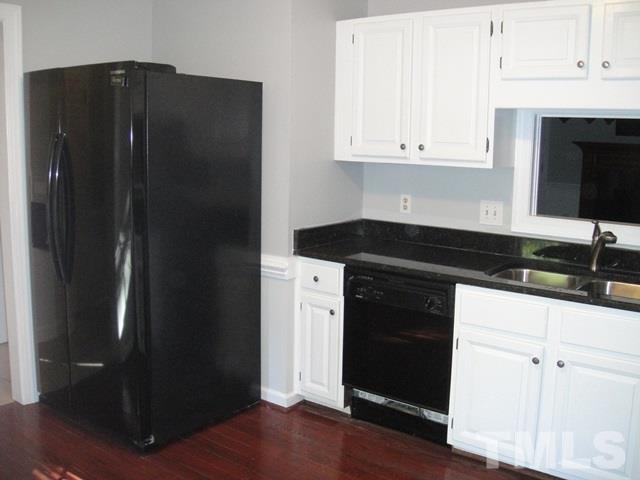 550 Weathergreen Drive Raleigh, NC 27615 - Photo 6 of 25 a kitchen with a refrigerator and cabinets