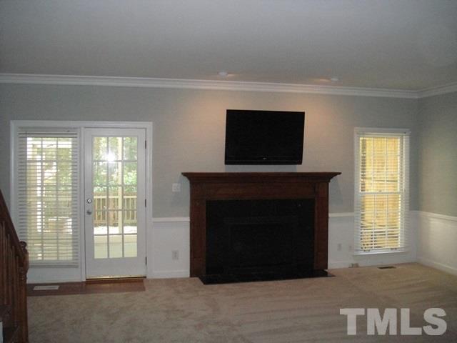 550 Weathergreen Drive Raleigh, NC 27615 - Photo 9 of 25 a living room with a fireplace and a flat screen tv