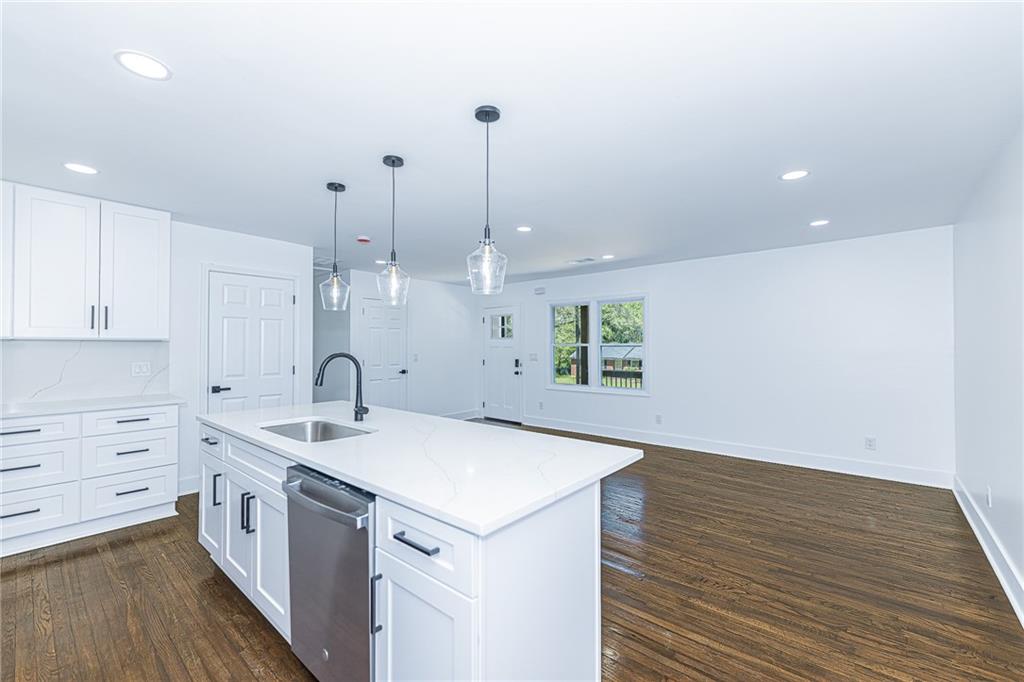 3013 Catalina Drive Decatur, GA 30032 - Photo 11 of 48 a kitchen with a sink dishwasher and white cabinets with wooden floor