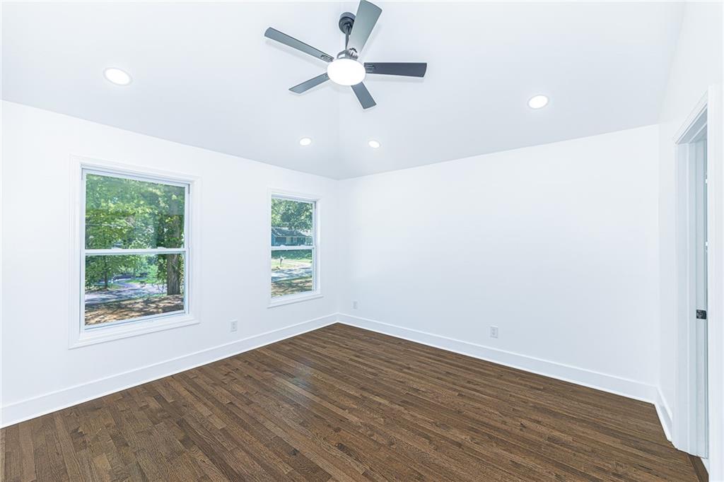 3013 Catalina Drive Decatur, GA 30032 - Photo 13 of 48 an empty room with wooden floor ceiling fan and windows