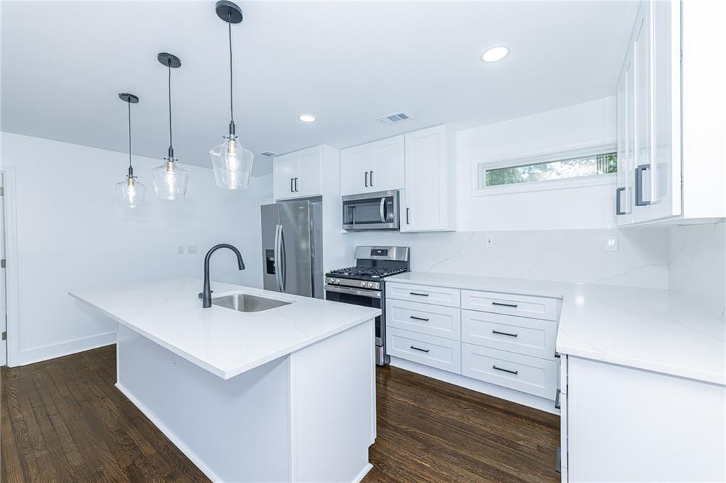 3013 Catalina Drive Decatur, GA 30032 - Photo 9 of 48 a kitchen with stainless steel appliances sink stove and cabinets