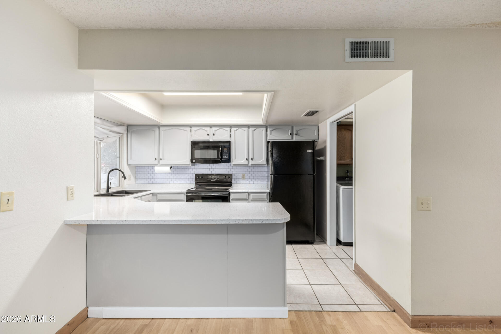 3004 West Phelps Road Phoenix, AZ 85053 - Photo 12 of 34 a kitchen with stainless steel appliances a refrigerator sink and microwave