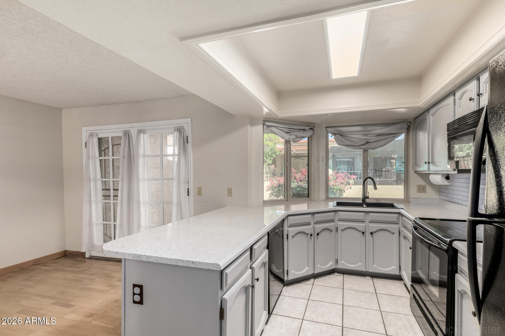 3004 West Phelps Road Phoenix, AZ 85053 - Photo 14 of 34 a kitchen with stainless steel appliances granite countertop a sink stove and cabinets