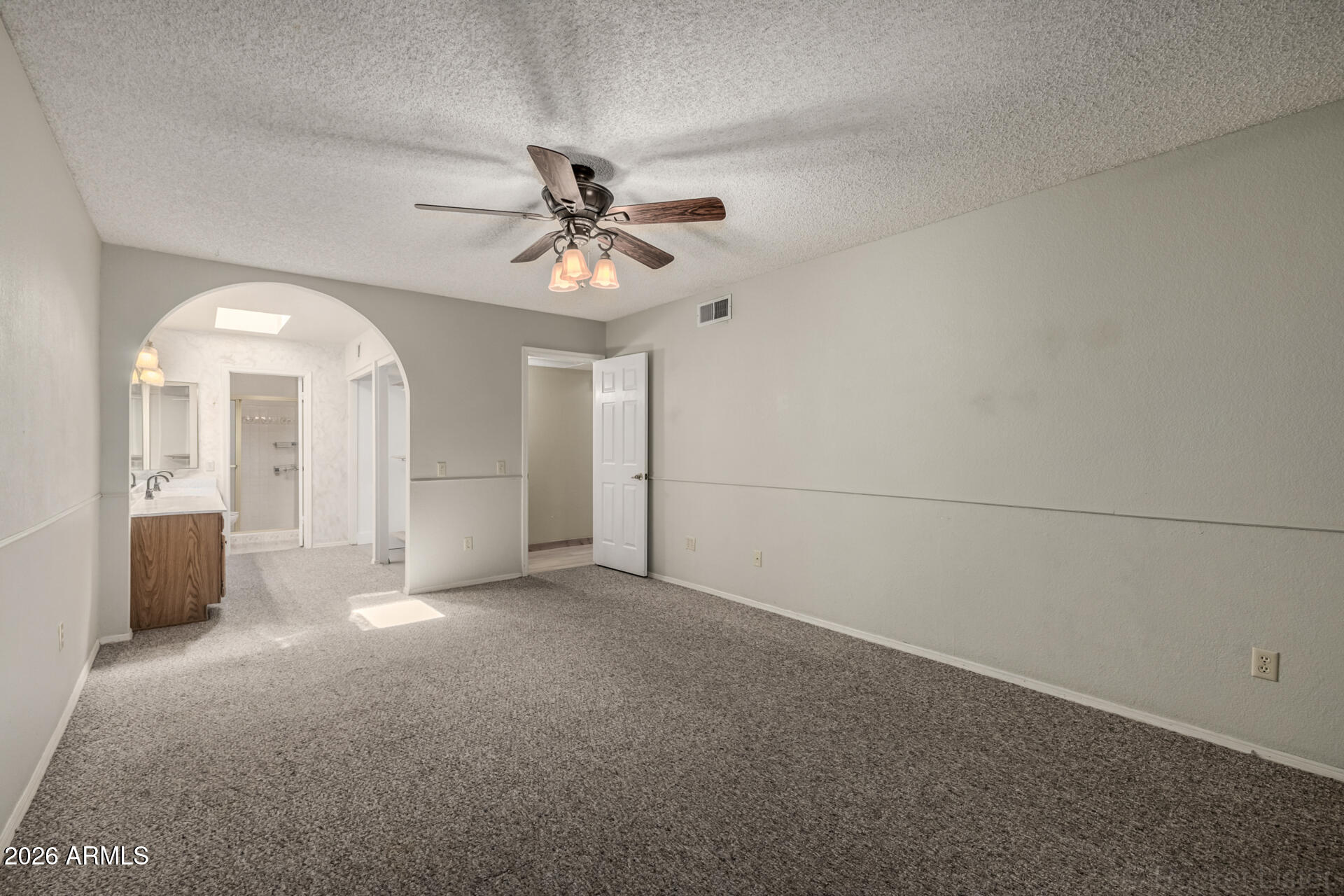 3004 West Phelps Road Phoenix, AZ 85053 - Photo 17 of 34 an empty room with chandelier fan and windows