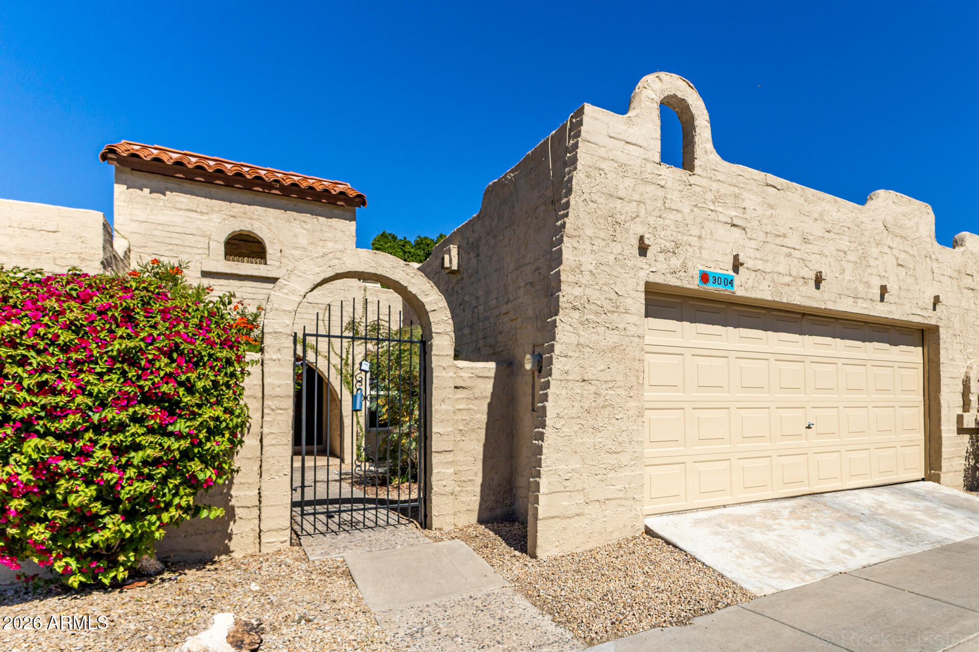 3004 West Phelps Road Phoenix, AZ 85053 - Photo 2 of 34 a front view of a house with a garden