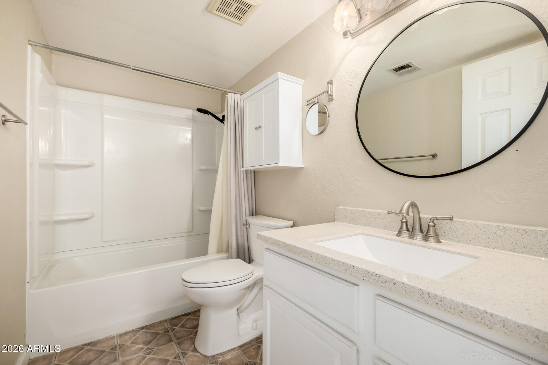 3004 West Phelps Road Phoenix, AZ 85053 - Photo 24 of 34 a bathroom with a sink a toilet and a mirror