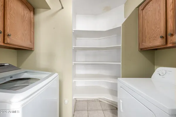 a utility room with sink dryer and washer