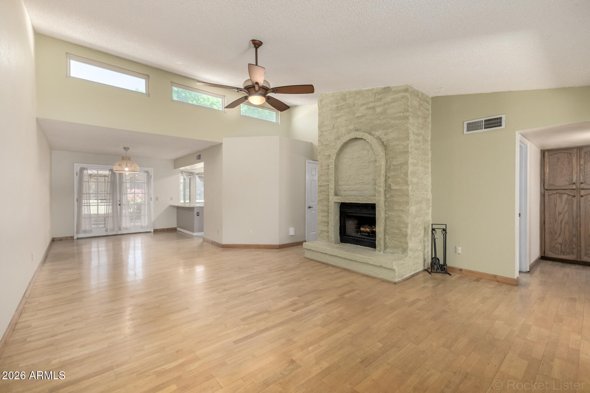 3004 West Phelps Road Phoenix, AZ 85053 - Photo 7 of 34 a view of an empty room with chandelier fan and fire place