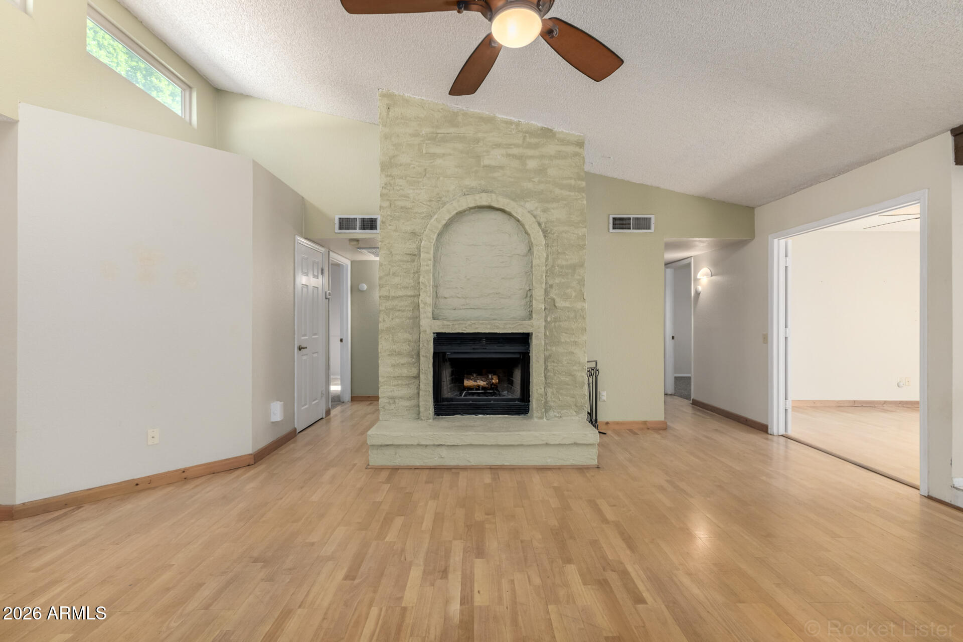 3004 West Phelps Road Phoenix, AZ 85053 - Photo 8 of 34 a view of an empty room with a fireplace and a window