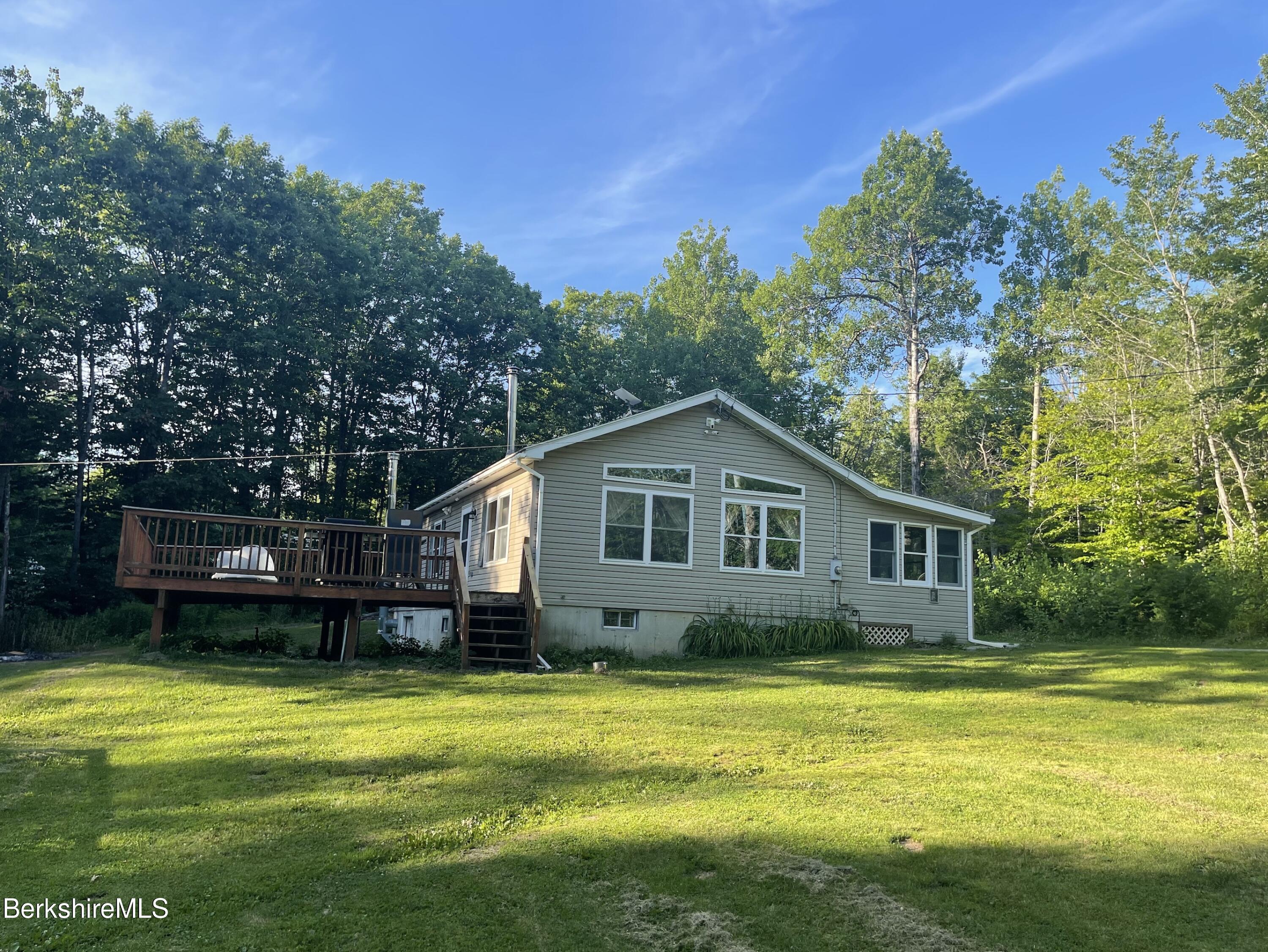 604 Loop Road Savoy, MA 01256 - Photo 1 of 23 a front view of a house with a yard table and chairs