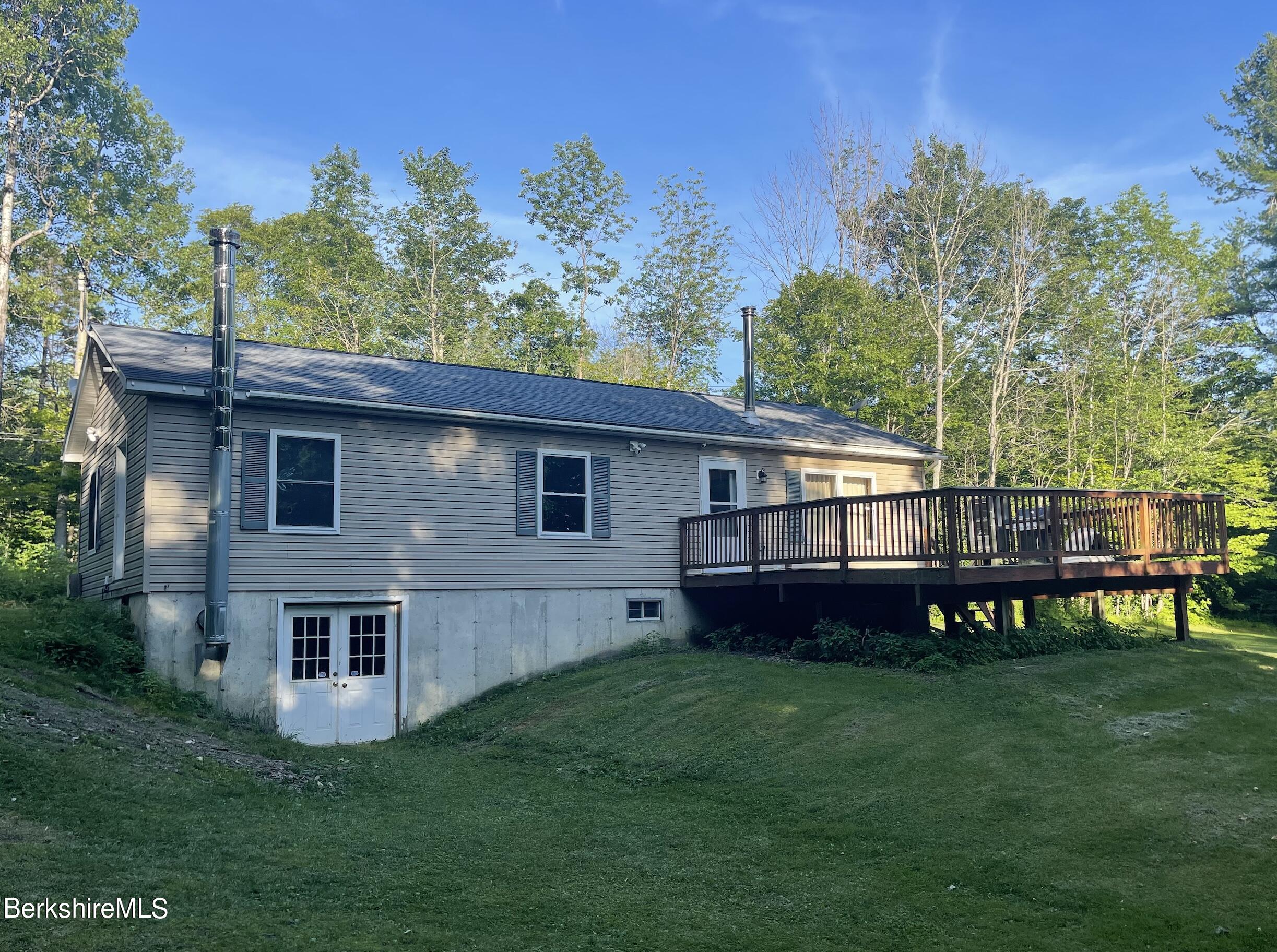 604 Loop Road Savoy, MA 01256 - Photo 14 of 23 a view of a house with a backyard and a patio